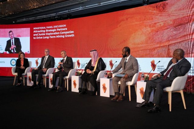 Panellists seated on a stage at a mining forum