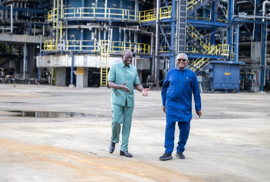Kenyan President William Ruto and Aliko Dangote walk and talk in front of a refinery complex