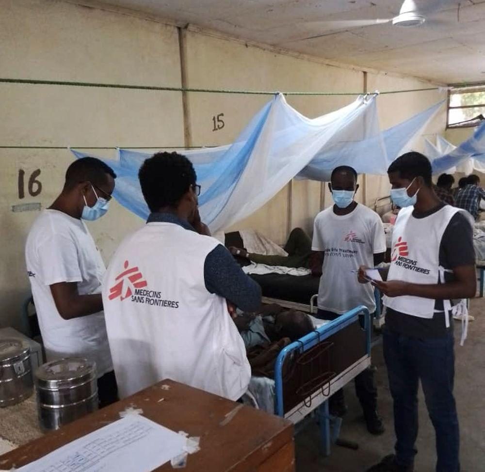 Medical staff in Doctors Without Borders vests attend patients in a hospital ward