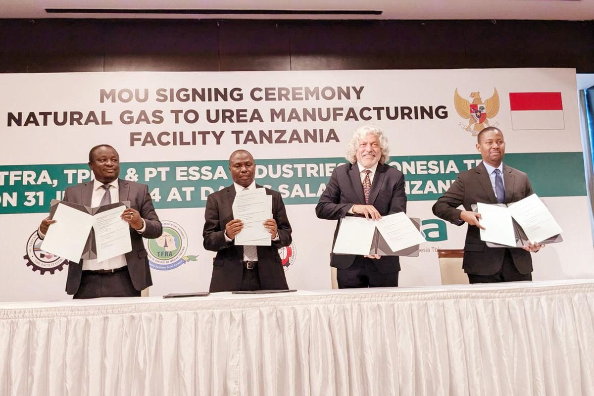 Officials hold signed documents at a signing ceremony for a natural gas to urea facility in Tanzania