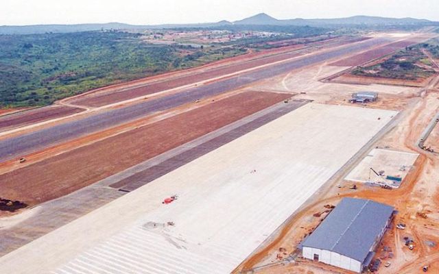 Aerial view of a new airport runway and buildings under construction